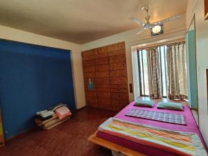 a bedroom with a large bed and a window at Garden Homes 1& 6 in Kolhapur