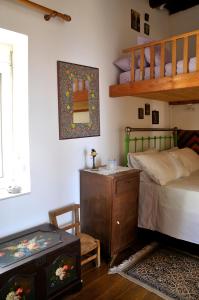 a bedroom with a bunk bed and a ladder at Morea Bay View in Tourlotí