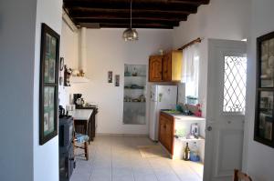 a kitchen with a refrigerator and a table at Morea Bay View in Tourlotí +15 photos