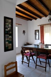 a dining room with a wooden table and chairs at Morea Bay View in Tourlotí