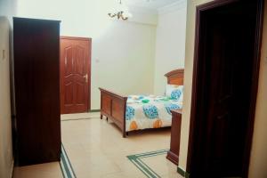 a bedroom with a bed and a closet and a door at Luxury Apartment with Ocean View in Oyster Bay in Dar es Salaam