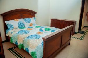 a bedroom with a bed and a dresser at Luxury Apartment with Ocean View in Oyster Bay in Dar es Salaam