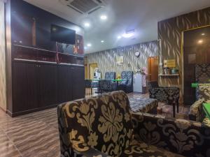 a bar with two chairs and a barber shop at SPOT ON 89858 Rebecca's Homes in Kota Kinabalu