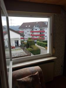 a window in a room with a view of a building at Sonnige ruhige Dachzimmer inkl WIFI plus Kaffee mit WG Dusche und neuer Küche in Lörrach