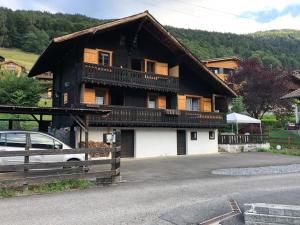 a house with a balcony on the side of it at Le Mazot in Troistorrents