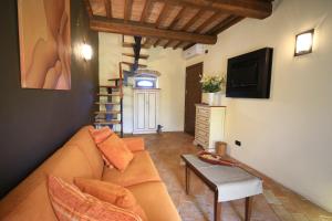 a living room with a couch and a table at Molino Di Foci in San Gimignano