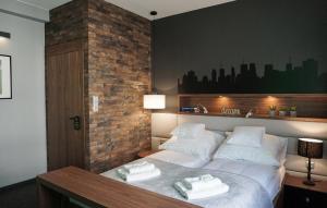 Łóżko lub łóżka w pokoju w obiekcie AGA Tenis Apartments by Radwańska