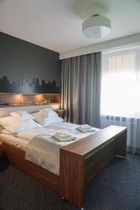 Łóżko lub łóżka w pokoju w obiekcie AGA Tenis Apartments by Radwańska