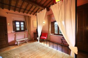 
a bedroom with a bed and a window at Molino Di Foci in San Gimignano
