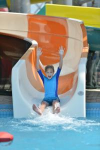a young boy sitting in the water on a roller coaster at Bella Vista Waterfront Resort, Kuah Langkawi in Kuah
