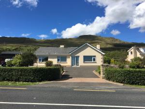 una casa in una strada con una montagna sullo sfondo di Atlantic View House a Killybegs