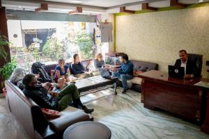 a group of people sitting in a living room at Alpine Hotel & Apartment in Kathmandu