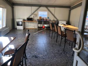 a room with tables and chairs and a kitchen at Hotel Sabina in Riga