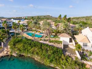 an aerial view of a resort with palm trees and a pool at Palms & Pools apartment at Curacao Ocean Resort in Willemstad