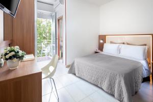 A bed or beds in a room at Hotel Foglieri