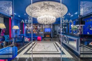 a room with a chandelier and blue walls at Boutique Hotel Albora in Saint Petersburg