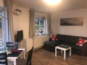 a living room with a couch and a table at Harz-Glück1 in Braunlage