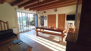 a living room with a bench in the middle at La Ferme du Père in Kermorocʼh