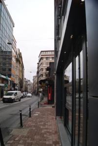 a brick sidewalk next to a street with a building at Sherry Suites Karaköy in Istanbul