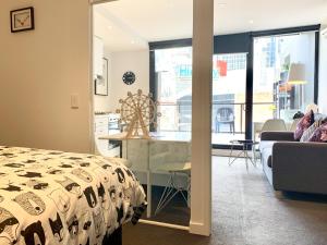 um quarto com uma cama, uma mesa e uma cozinha em ReadySet Apartments on Little Collins em Melbourne