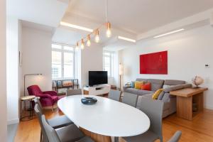 a living room with a white table and a couch at FLH Chiado Amazing Flat in Lisbon