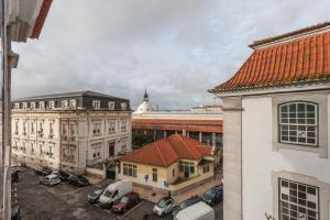 an aerial view of a city with buildings and cars at FLH Chiado Amazing Flat in Lisbon