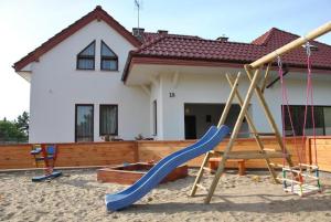 plac zabaw ze zjeżdżalnią przed domem w obiekcie Wiktoria-Biały Domek w Jastrzębiej Górze
