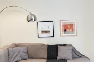 a living room with a couch and a lamp at Two bedroom apartment in Kesariani in Athens