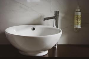 a white sink with a faucet in a bathroom at Cascais City & Beach Hotel in Cascais +19 photos