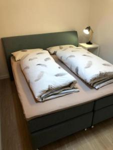 a bed with two pillows on top of it at Ferienwohnung Zum Fiaker in Garmisch-Partenkirchen