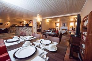 a dining room with a table and chairs and a fireplace at Archontiko Argyro in Makrinítsa