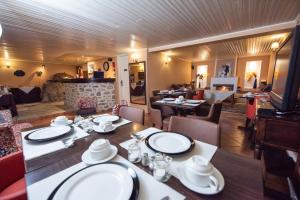 a dining room with a table and chairs and a fireplace at Archontiko Argyro in Makrinitsa