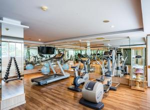 a gym with treadmills and elliptical machines at Riva Surya Bangkok - SHA Extra Plus in Bangkok