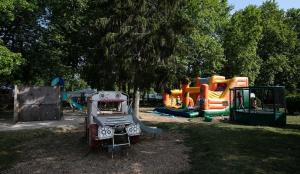 a park with a playground with a slide and a play structure at Camping La Belle Etoile in Melun