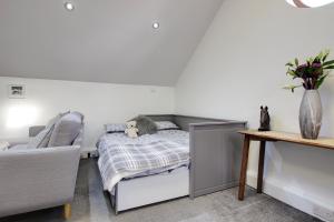 a bedroom with a bed with a stuffed animal on it at The Loft at Ard Gleann in Kirkistown