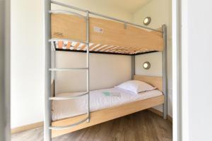 a bunk bed in a small room with a ladder at Résidence Pierre & Vacances Premium Port Prestige in Antibes