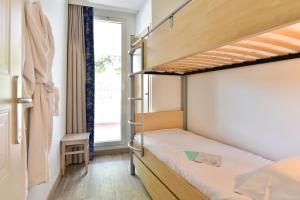 a bedroom with two bunk beds and a window at Résidence Pierre & Vacances Premium Port Prestige in Antibes
