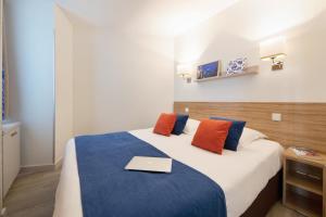 a bedroom with a bed with a laptop on it at Résidence Pierre & Vacances Premium Port Prestige in Antibes