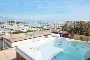 a hot tub on a balcony with a view of a marina at Résidence Pierre & Vacances Premium Port Prestige in Antibes
