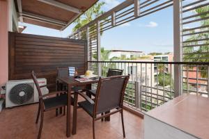 a balcony with a wooden table and chairs on a balcony at Résidence Pierre & Vacances Premium Port Prestige in Antibes