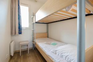 a small bedroom with a bunk bed and a ladder at Résidence Pierre & Vacances Premium Port Prestige in Antibes