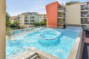 a swimming pool in the middle of a building at Résidence Pierre & Vacances Premium Port Prestige in Antibes