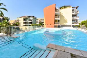 a swimming pool in the middle of a building at Résidence Pierre & Vacances Premium Port Prestige in Antibes
