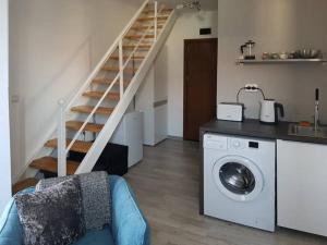 a living room with a staircase and a washing machine at SP Luxury Loft 28 in Ravda