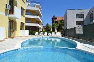a large swimming pool in front of a building at SP Luxury Loft 28 in Ravda
