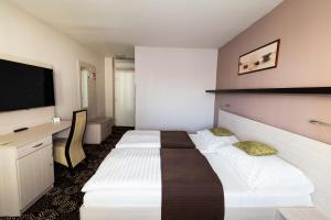 Łóżko lub łóżka w pokoju w obiekcie Parkhotel Plzen Congress Center