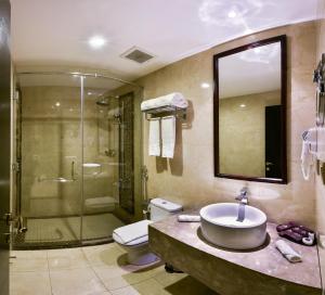 a bathroom with a sink and a shower and a toilet at Braira Al Azizya Hotel & Resort in Al Khobar
