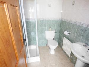 a bathroom with a toilet and a sink at No 17 Mountain Dale in Tullaghan +7 photos