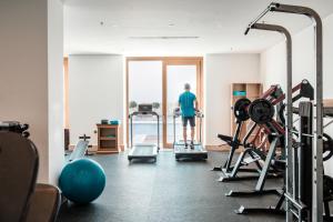 a man standing in a gym looking out the window at Mitsis Selection Blue Domes in Kardamaina