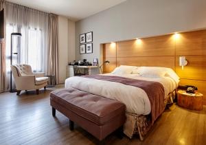 a hotel room with a large bed and a chair at Hotel Barcelona Catedral in Barcelona